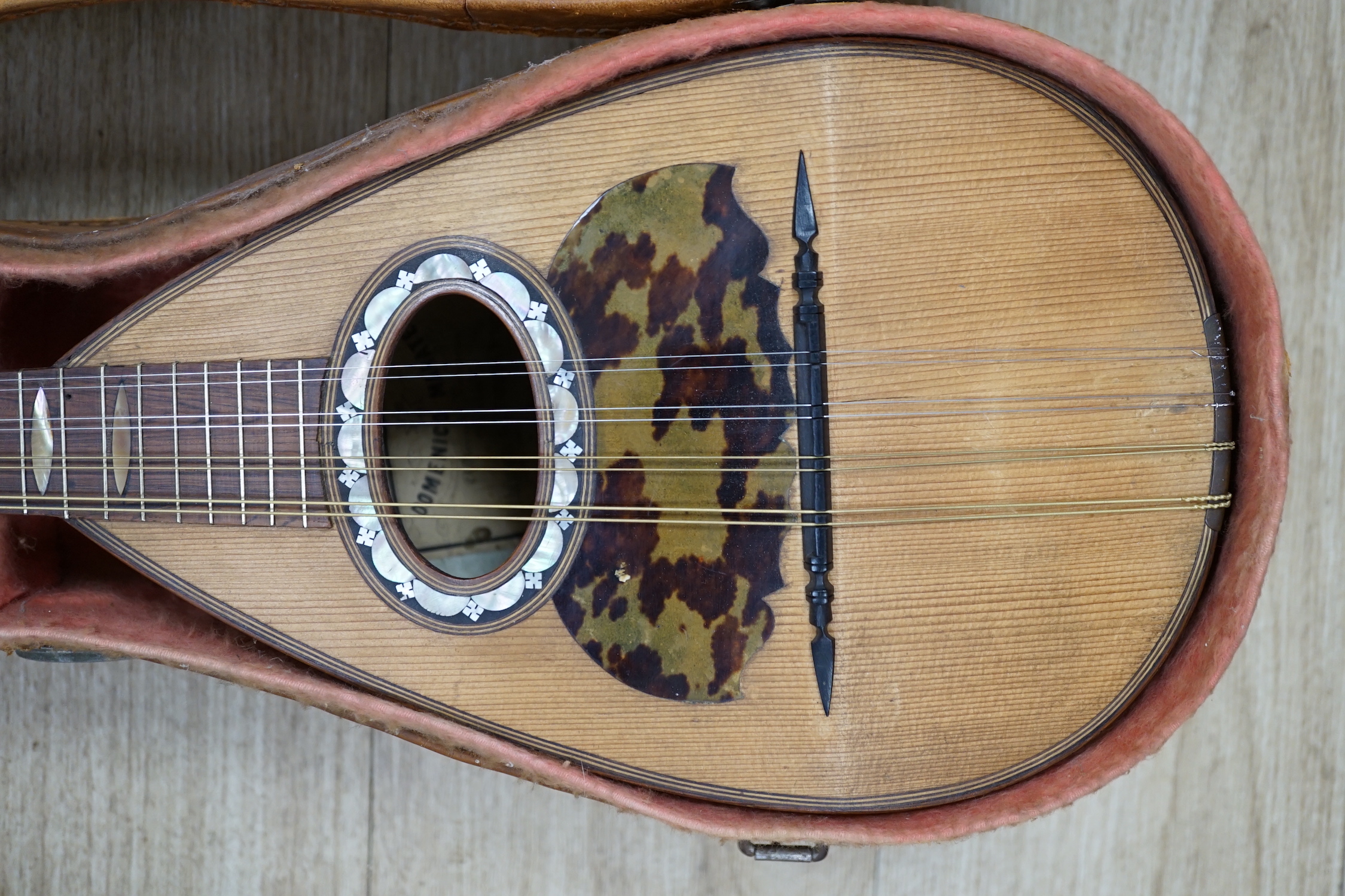 A cased Italian mandolin, labelled Domenico Maratea, and Fratelli Vinaccia, Naples, bowl backed body, length of body 30cm, with some packeted spare strings